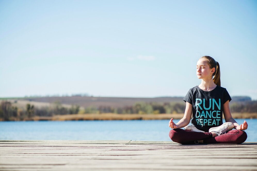 teenager sitting pier lotus position 23 2147707631